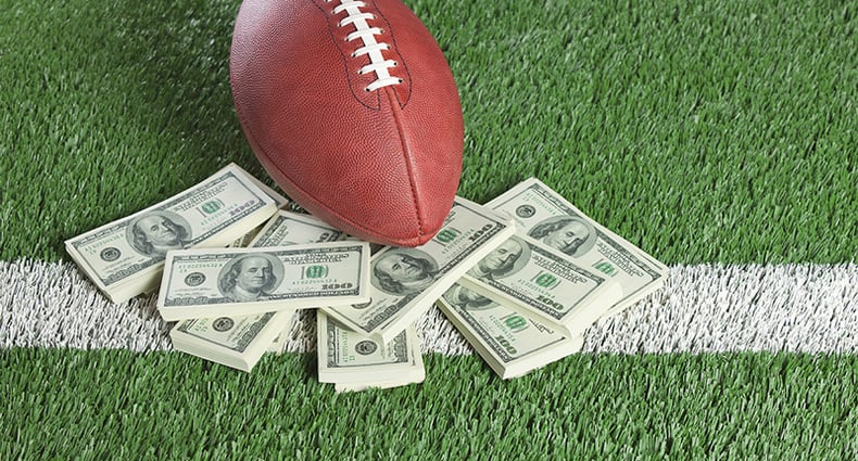 football and money on football field