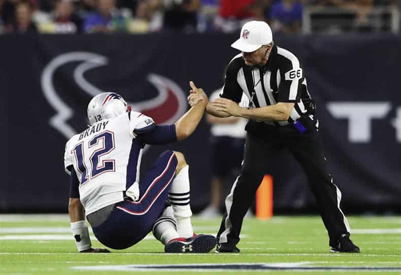 Referee helps Tom Brady up