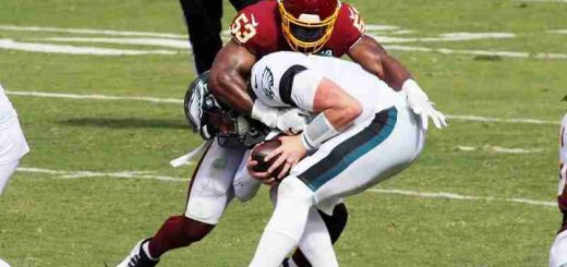 Eagles player getting tackled by a Washington player