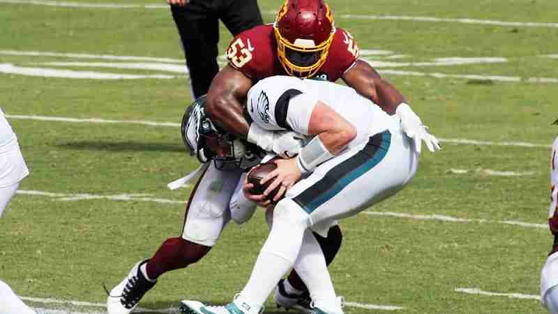 Eagles player getting tackled by a Washington player