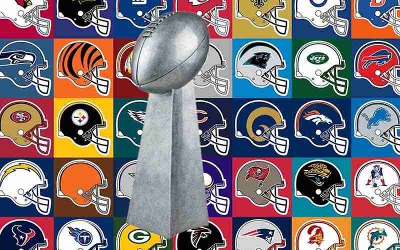 Lombardi Trophy in front of wall of NFL team helmets