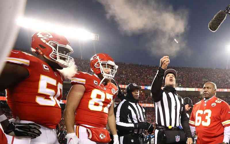 referee performing Super Bowl LV coin toss with Chiefs watching