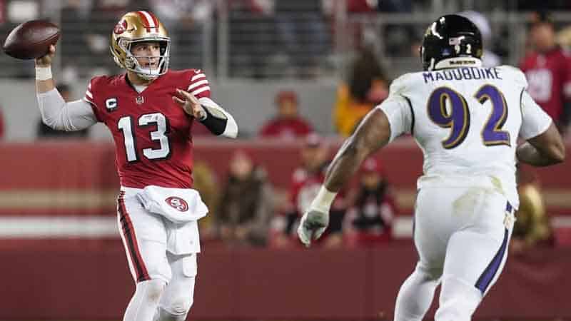 Brock Purdy of the San Francisco 49ers avoiding a Baltimore Ravens pass rush